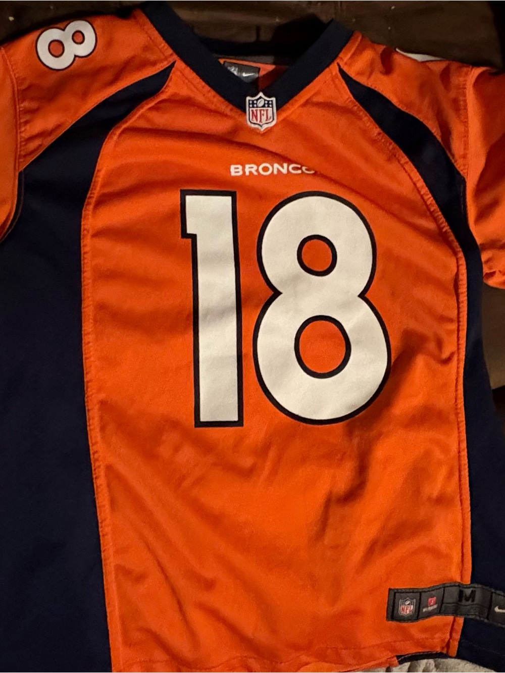 NFL Kids Orange & Navy Broncos #18 Jersey does have small stain as pictured.